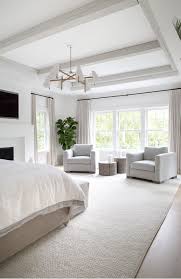 Large Master Bedroom With Extra Large Area Rug Brass Chandelier Two Sofa Chairs In The Master Be Master Bedrooms Decor Neutral Master Bedroom Large Bedroom