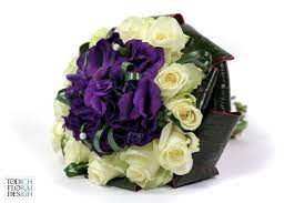 Its wonderful fragrant blooms are also found across the uk and its colour range from pale lilac to deep violet. Deep Purple Lisianthus Surrounded By A Contrasting Frame Of Ivory Avalanche Roses And Dark Cord Beautiful Bouquet Of Flowers Flower Delivery Uk Bridal Bouquet