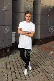 If you have a khaki pant at home then it could make a perfect pair with a black shirt. Handsome Young Hipster Stylish Man In White Shirt Black Pants Stock Photo Picture And Royalty Free Image Image 64080555