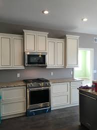 Beautiful Tall White Staggered Cabinets With Stainless Steel Oven And Microwave No Hardwa Staggered Kitchen Cabinets Modular Home Builders Staggered Cabinets