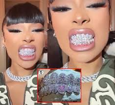 Oh my. Megan Thee Stallion showing off her new Diamond GRILL made by  Grillzbyjohnnygang. It's Dope but seems like they would hurt your lips. How  much you think she paid?
