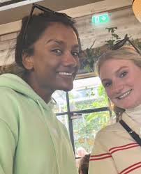 Simone Ashley with a fan