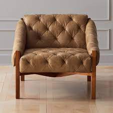 Designed with rolled arms and tapered legs, the club chair is finished with exquisite stitching detail and chic tufted cushions. Abruzzo Brown Leather Tufted Chair Reviews Cb2