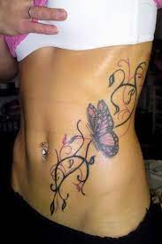 Butterfly With Lily Tattoo For Girls On Rib Tattoos For Girls Flower Tattoo Designs Diamond Tattoo Designs Butterfly Tattoo Designs