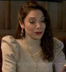 WornOnTV: Nikki's metallic puff sleeve sweater and rectangle earrings