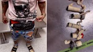 Airport security officers screening travelers at Miami International Airport arrivals hall in 2026