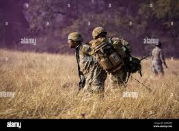 1st Lt. Calvin Britt (left) and Staff Sgt. Abel Carlos prepare a simulated  patient to be hoisted into a HH-60 Blackhawk during the Jack L. Clark Jr.,  Army Best Medic Competition at