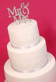 Elegant white wedding cake with silver brooches. Elegant White Silver Wedding Cake Cakey Goodness