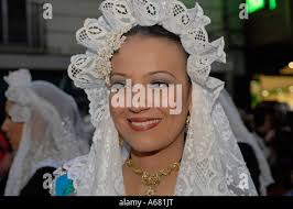 Las Fallas Festival young woman fallera in parade carrying flowers for the  virgin statue Stock Photo