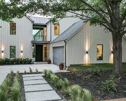 Board and batten, stucco, and stone exterior for a luxe urban style. Urban Lake House Contemporary Farmhouse Exterior Modern Farmhouse Exterior Lake Houses Exterior