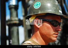 Petty Officer 2nd Class Casey Allan, an aviation maintenance technician  from Coast Guard Air Station Barbers Point, Oahu, autographs 12-year-old  Felix Kehano's t-shirt during a D.A.R.E. event for Kualapuu Public Charter  School