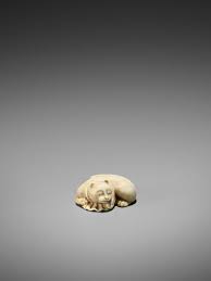 An ivory netsuke of a sleeping spotted cat. Lot 139 A Rare Ivory Netsuke Of A Sleeping Cat