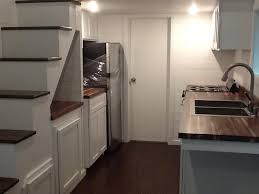 Use a bright white color scheme and smart positioning to create a less stuffy kitchen. American Tiny House San Francisco Kitchen Cabinets American Tiny House