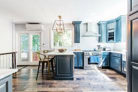 Kitchen painted with blue lower and white upper cabinets. Eight Blue Kitchens That Prove The Color Is A New Classic
