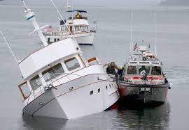 three rescued from sinking boat in port