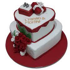 This wedding cake design idea comprises of three iced heart wedding cakes at the bottom tier and one heart cake at the top. Engagement Cakes Online Heart Shaped Design In Faridabad