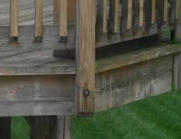 Wood stained rails to match the deck with glass vertical panels. Deck Railing Posts Inside Vs Outside Of The Rim Joist