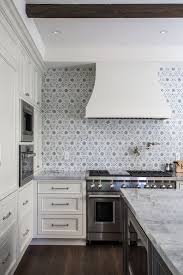 Black And White Spanish Tile Backsplash Spanish Transitional Style Kitchen With Patterned Tile Backsplash White Cabinets And Dark Wood Flooring Ivory Kitchen Kitchen Trends Ivory Kitchen Cabinets