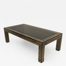 This vintage hollywood regency coffee table made by american furniture maker mastercraft features a polished brass base with a curved x stretcher supporting four legs with decorative feet, as well as a thick beveled oval glass top. Bernhard Rohne Acid Etched Brass Coffee Table By Bernhard Rohne For Mastercraft