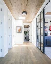 The Textured Pecky Cedar Tongue And Groove Ceiling And Rustic Driftwood Hardwood Floor Planks Of This Hallway Ca Hallway Designs Home Tongue And Groove Ceiling