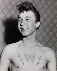 Eric Jarvis with tattoos done by Eric Simister. May 30th, 1960. Original  Newspaper Caption: “15 year old schoolboy Eric Jarvis displays his tattoos.  Tattooed schoolboys at Featherstone. 21 year old miner Eric