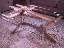 The table is filled with funky colors that go well with the science fiction genre. Your Cat Is Eager To Pilot This Star Wars X Wing Coffee Table The Mary Sue