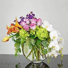 Contemporary Floral Design Of Orchids Orange Calla Lilies And Roses 2019 Floral Decor In 2021 Contemporary Flower Arrangements White Flower Arrangements Flower Arrangements