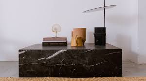 This gathering table features a solid wood tabletop and solid wood base with an antique silver finish to create a faux metal design. Marble Block Coffee Table Nero Marquina Black Aime Te