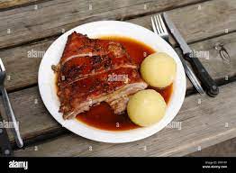 Suckling Pig with Dumplings served in a beer garden in Taxisgarten, Munich,  Bavaria, Germany, Europe Stock Photo - Alamy
