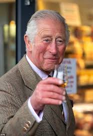 Prince Charles wears a kilt and sips a ...