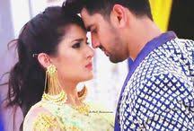 neil and priya pinned to wall