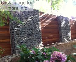 Gabion is a steel cage filled with earth or rocks and used especially in building as support or buttress. Gabion Stone Fences Gabion Fence Gabion Wall Fence Design