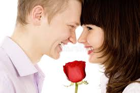 A Guy and a Girl Holding a Rose and Look at Each Other Stock Photo