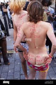 Two teenage boys strip naked and pretend to offer themselves to the Pope  during a 10,000 strong march through Central London Stock Photo - Alamy