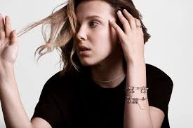 Her smoky eye makeup and perfectly messy hair are paired with a ruffled blouse. Millie Bobby Brown Named Brand Ambassador For Pandora Wwd