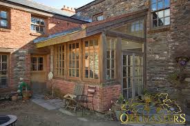 The rebirthed sunroom now stretches its seasonality thanks to locally sourced granite floors. Rustic Sunroom On The Isle Of Man Oakmasters