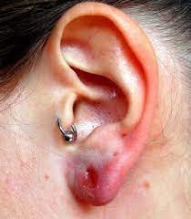 20 Tiny Tattoos With Big Meanings Infected Ear Piercing Ear Piercings Baby Ear Piercing