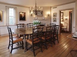 The bold red chairs around this table look so chic against the dark wood. A Traditional New England Style Dining Room Colonial Dining Room New England Style Homes Traditional Dining
