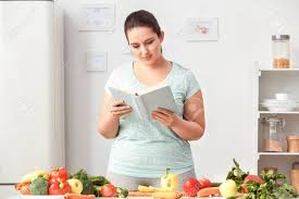 A kitchen is a room or a place in a house where food is prepared and served. Cooking Meal Chubby Girl Standing In Kitchen Reading Book Of Stock Photo Picture And Royalty Free Image Image 133671077