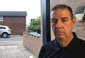 Couple living with broken doors and rough sleepers in hallway of Orbit  Housing Association flat in Carpeaux Close, Chatham