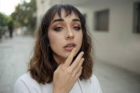 People riding parachute over brown mountain during daytime photo