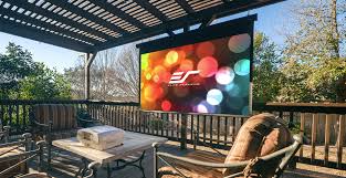 Backyard theater screen shot with back lattice panels lit. Outdoor Movie Theater Checklist