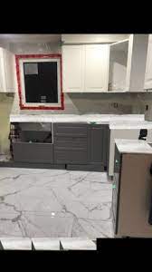 Delicatus white granite kitchen countertops contrasted with a blue eyes granite island. Delicatus Granite To White Grey Cabinets With Calacatta Floor