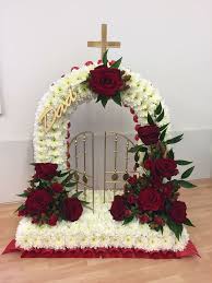 White Based Gates Of Heaven Funeral Tribute With Red Rose Sprays And Gold Accent Funeral Flower Arrangements Funeral Flowers Easter Flower Arrangements