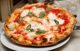 A round of doughy crust topped with tomato and mozzarella. In Pizzeria A Delicious Italian Language Lesson Italy Magazine