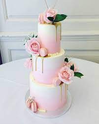 Three Tier Wedding Cake With Soft Pink Ombre Gold Drip Macarons And Fresh Flowers Fo Beautiful Wedding Cakes Country Wedding Cake Toppers Pink Wedding Cake