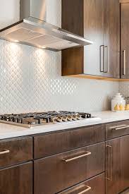 This Kitchen Is Serving Serious Style White Textured Backsplash With Brown Cupboards And Gold Brown Kitchen Cabinets Gold Kitchen Hardware Home Decor Kitchen