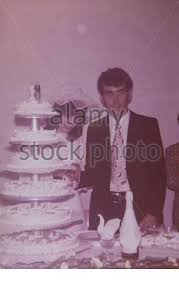The video starts in 1916, when cakes were super simple — just a single white tier with some white flowers on top. Newlyweds With Wedding Cake 60s 2 Stock Photo Alamy
