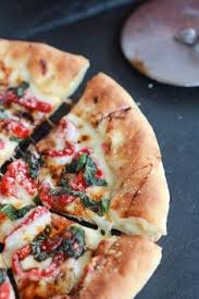Green Olive Pesto Pizza With Feta Stuffed Crust Roasted Red Peppers And Balsamic Drizzle Half Baked Harvest Recipe Olive Pesto Pesto Pizza Stuffed Peppers