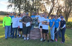 Rotary members pick up trash during Save Our Waters Week